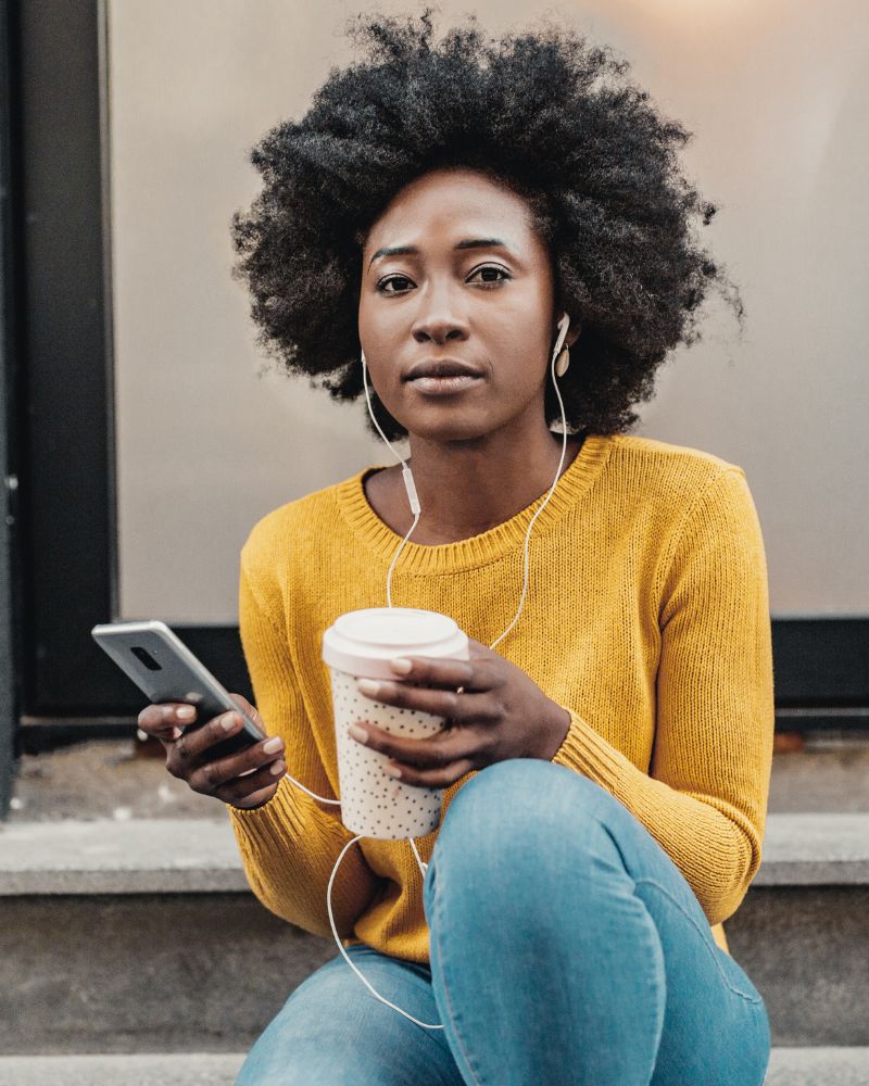 young lady with headphones and mobile device