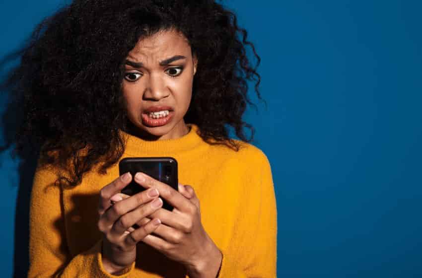 Adult woman on cell phone with a confused face