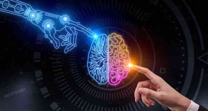 top left is a robotic artificial intelligence  hand from lights and on the bottom right is a human hand. Both hands are touching a brain which is half human, half artificial intelligence.